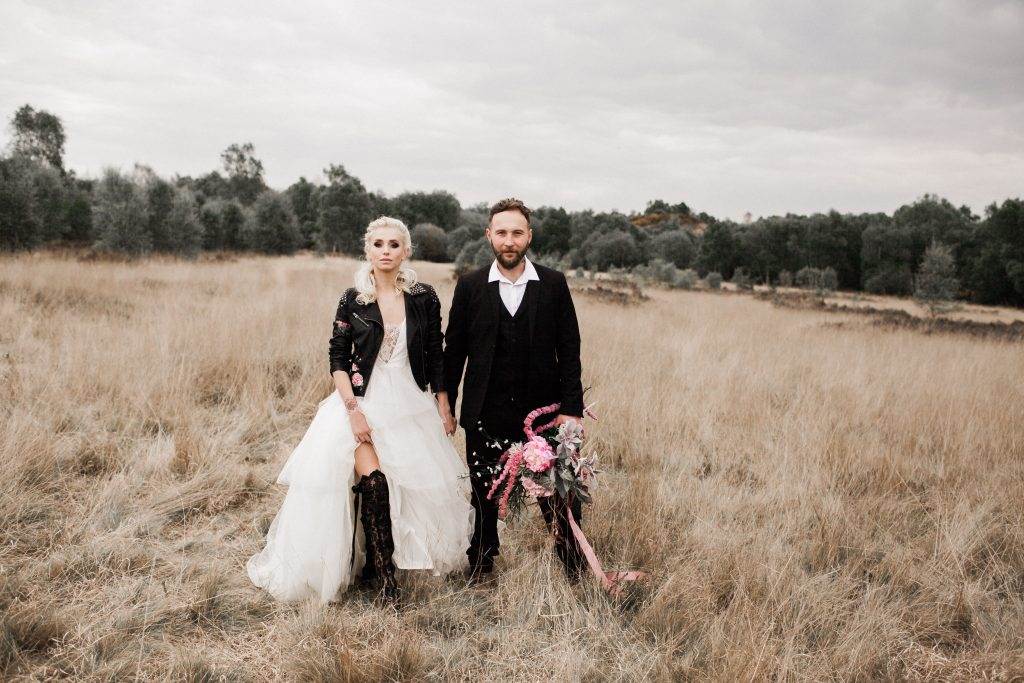 A dark moody wedding shoot with a painted leather jacket