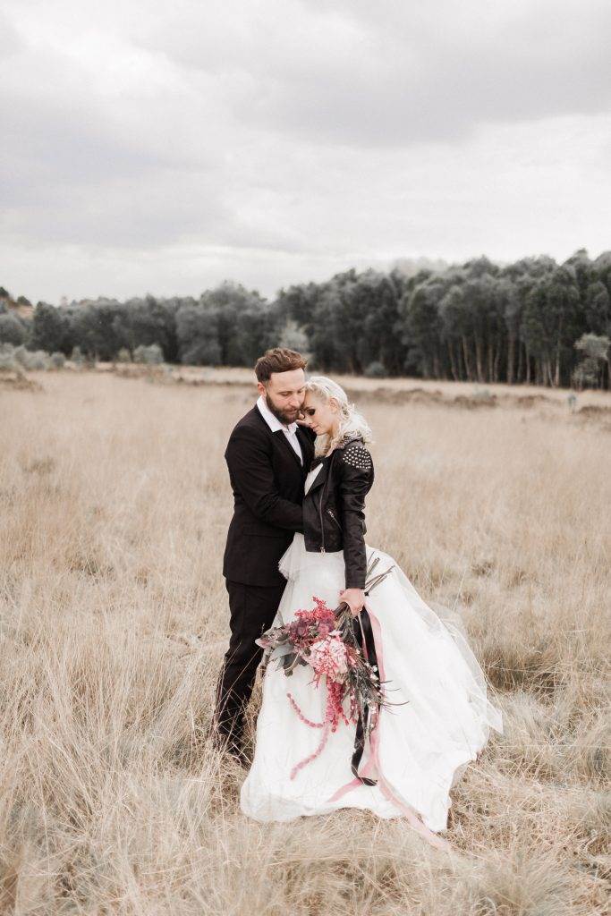 A dark moody wedding shoot with a painted leather jacket