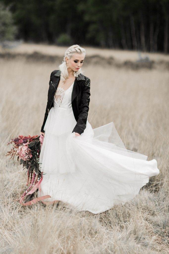 A dark moody wedding shoot with a painted leather jacket